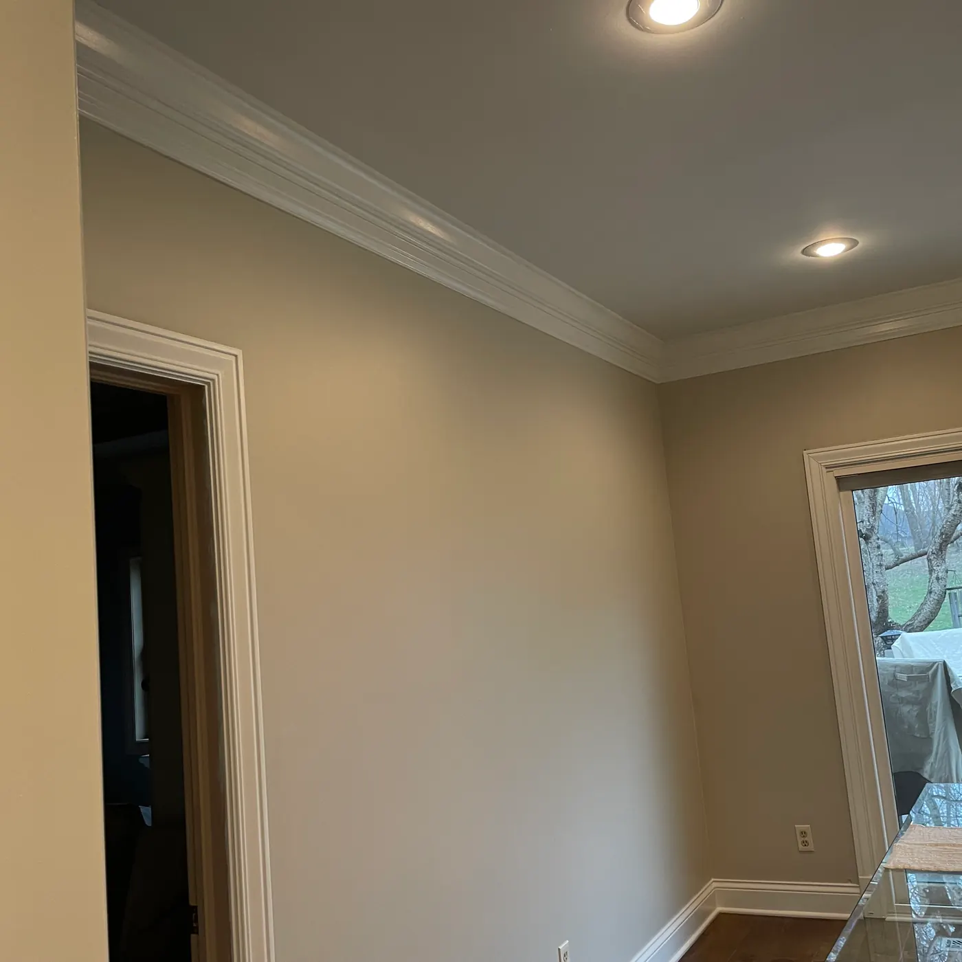 Room corner with warm beige walls and crisp white crown molding